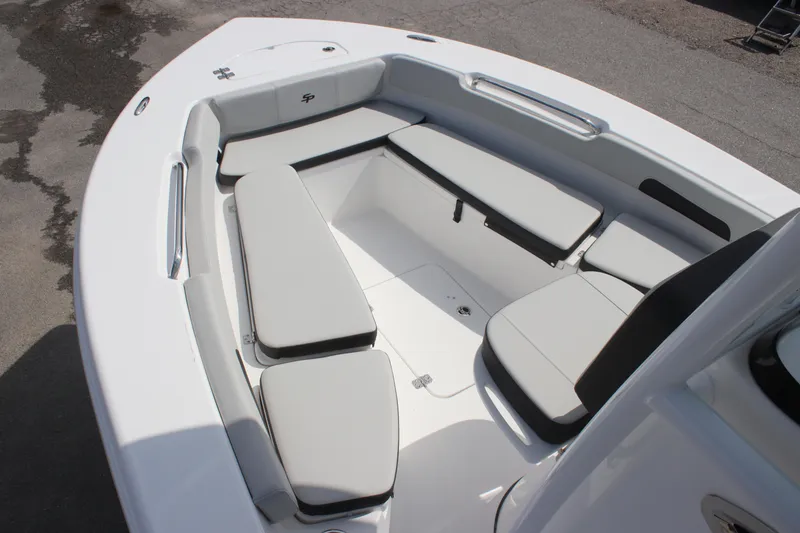 Slide: The Image of 2025 Sea Pro 202 CC boat interior with cushioned seating and sleek design. - 13