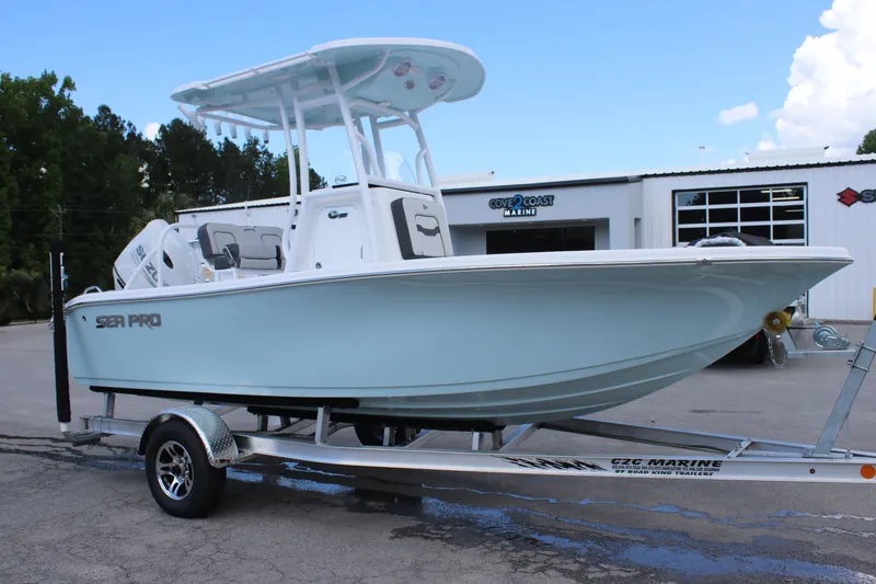 Slide: The Image of 2025 Sea Pro 202 CC boat on trailer outside dealership. - 2