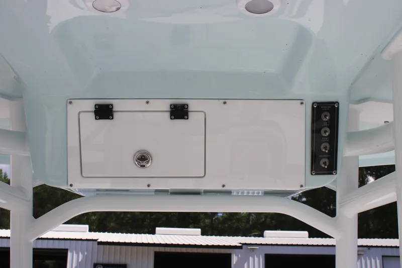 Slide: The Image of 2025 Sea Pro 202 CC boat console with storage compartment and control panel. - 22