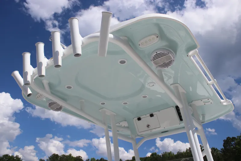 Slide: The Image of 2025 Sea Pro 202 CC boat top with rod holders against a cloudy sky. - 23