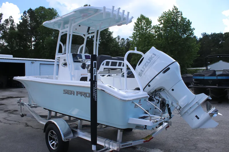 Slide: The Image of 2025 Sea Pro 202 CC boat on trailer with Suzuki outboard motor, parked outdoors. - 4