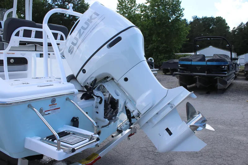 Slide: The Image of 2025 Sea Pro 202 CC boat with Suzuki outboard motor, parked outdoors. - 5