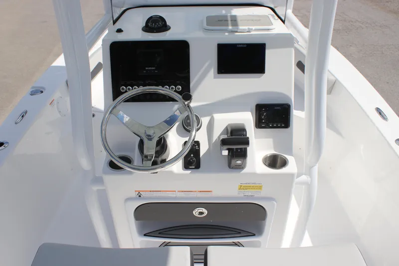 Slide: The Image of 2025 Sea Pro 202 CC boat console with steering wheel, controls, and navigation displays. - 7