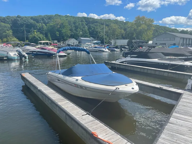 Slide: The Image of 2004 Sea Ray 185 Bow Rider docked at a marina on a sunny day. - 0