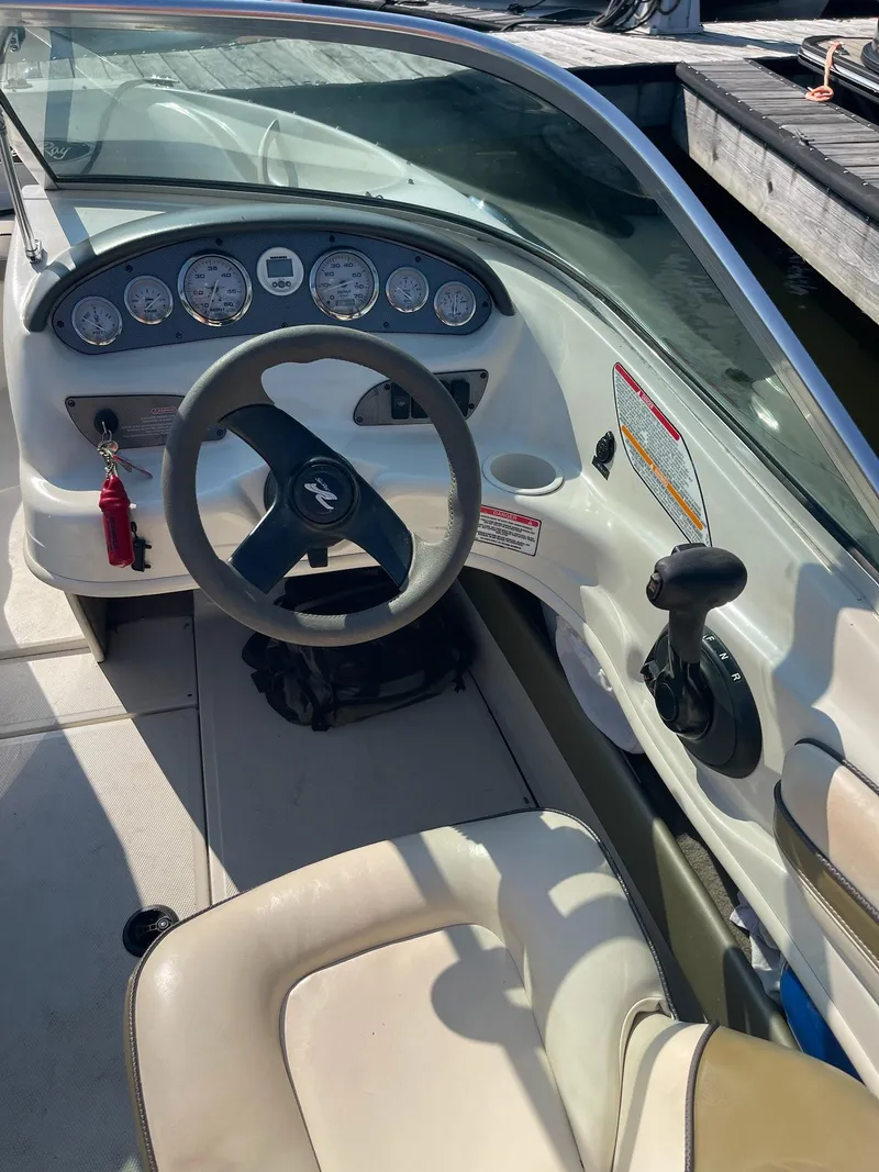 Slide: The Image of 2004 Sea Ray 185 Bow Rider dashboard and steering wheel, docked at marina. - 10