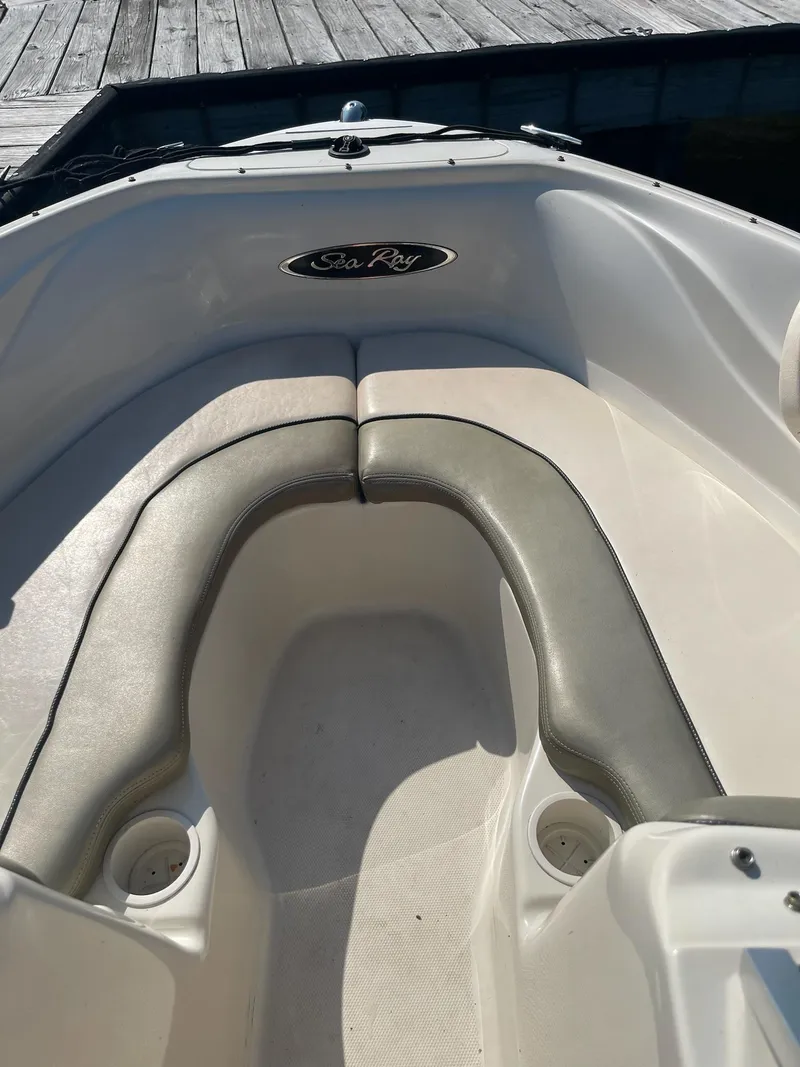 Slide: The Image of 2004 Sea Ray 185 Bow Rider boat interior with seating and cup holders. - 17