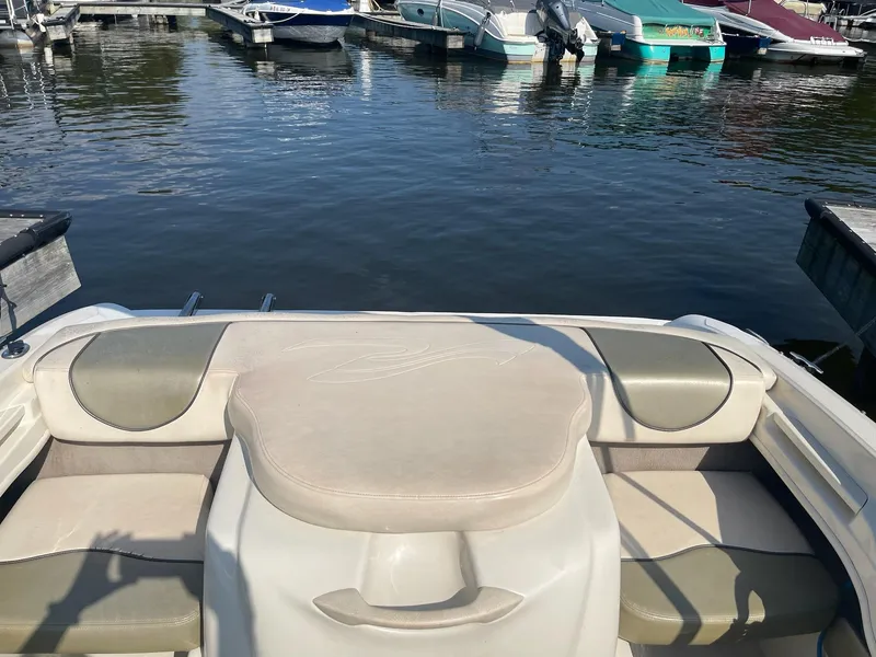 Slide: The Image of 2004 Sea Ray 185 Bow Rider boat interior at a marina dock. - 18