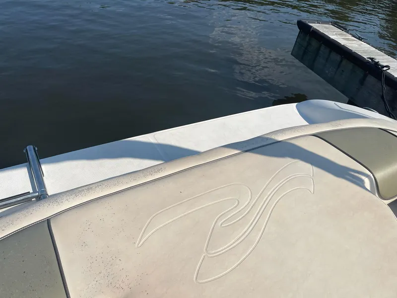 Slide: The Image of 2004 Sea Ray 185 Bow Rider boat near a dock on calm water. - 20