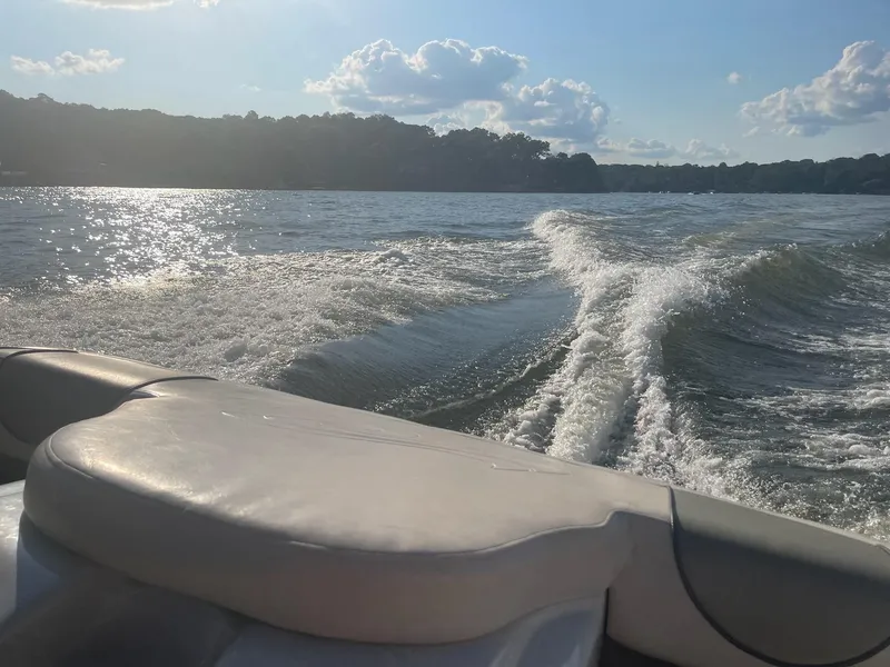 Slide: The Image of 2004 Sea Ray 185 Bow Rider cruising on a sunny lake, leaving a wake behind. - 22