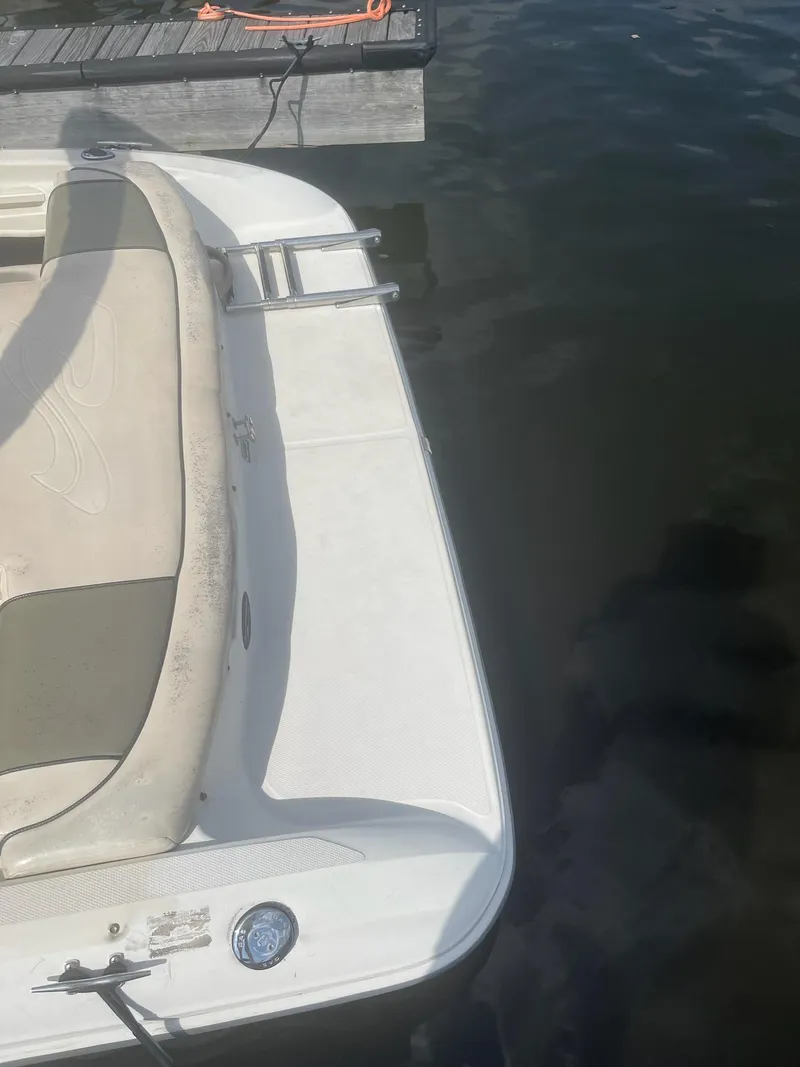 Slide: The Image of 2004 Sea Ray 185 Bow Rider docked on calm water. - 25