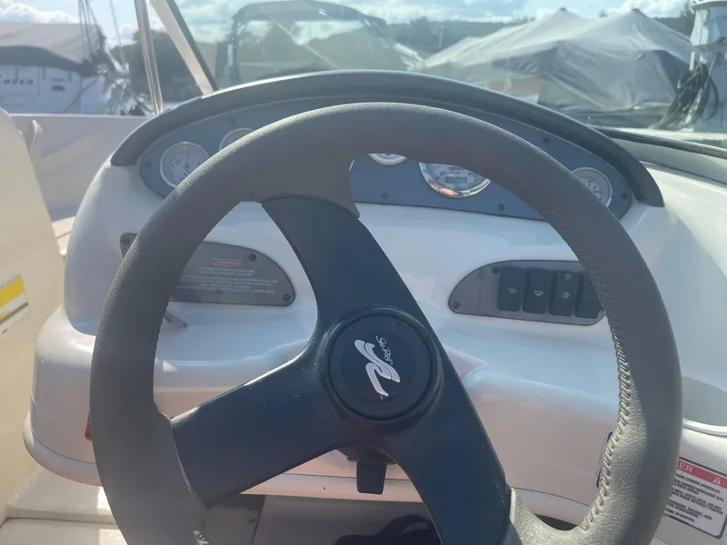 Slide: The Image of Steering wheel of a 2004 Sea Ray 185 Bow Rider boat dashboard. - 6