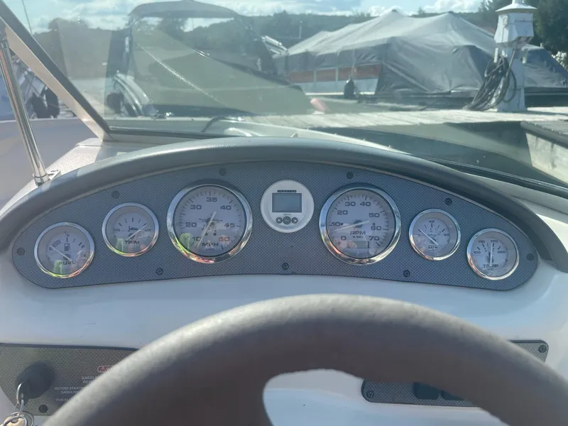 Slide: The Image of Dashboard of a 2004 Sea Ray 185 Bow Rider boat with gauges and steering wheel. - 7