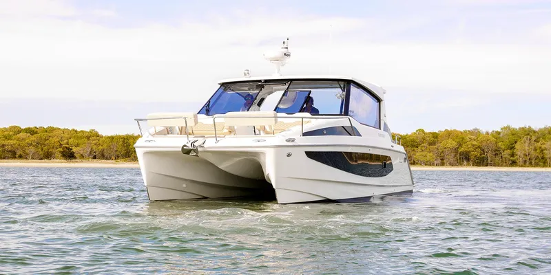 Slide: The Image of Aquila 36 Sport 2021 cruising on a serene body of water. - 12