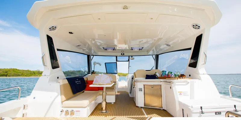 Slide: The Image of Aquila 36 Sport 2021 boat interior with seating and kitchenette on open water. - 16