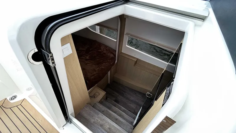 Slide: The Image of Interior cabin view of 2021 Aquila 36 Sport, featuring stairs and cozy sleeping area. - 29