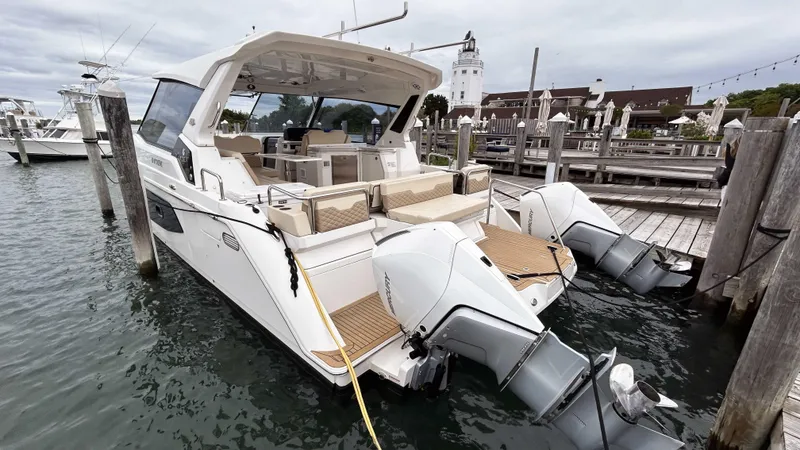 Slide: The Image of Aquila 36 Sport 2021 docked at marina with lighthouse in background. - 3