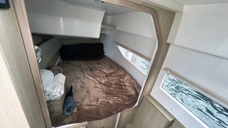Slide: The Image of Cozy cabin interior of 2021 Aquila 36 Sport with plush bedding and window views. - 30