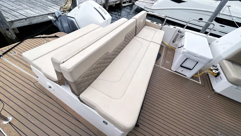 Slide: The Image of Aquila 36 Sport 2021 boat with beige seating and teak deck at a marina. - 31