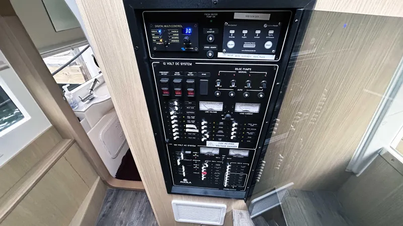 Slide: The Image of Control panel of 2021 Aquila 36 Sport boat, featuring various switches and indicators. - 32