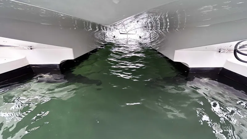 Slide: The Image of Underwater view of 2021 Aquila 36 Sport catamaran hull in green water. - 33