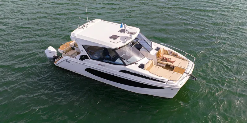 Slide: The Image of 2021 Aquila 36 Sport boat cruising on open water. - 34