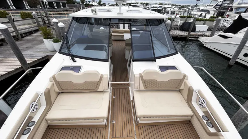 Slide: The Image of 2021 Aquila 36 Sport yacht with spacious deck and luxurious seating at a marina. - 7