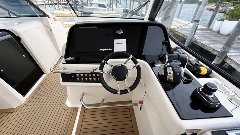Slide: The Image of 2021 Aquila 36 Sport boat helm with modern controls and sleek design. - 8
