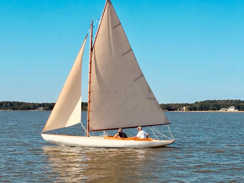 Slide: The Image of Sailing on a 1916 Herreshoff Buzzards Bay 15 in calm waters under clear blue skies. - 0