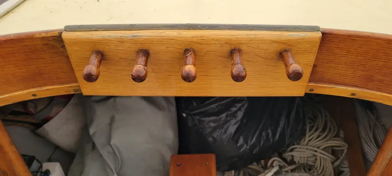 Slide: The Image of Wooden pegs on a 1916 Herreshoff Buzzards Bay 15 sailboat, showcasing classic craftsmanship. - 5