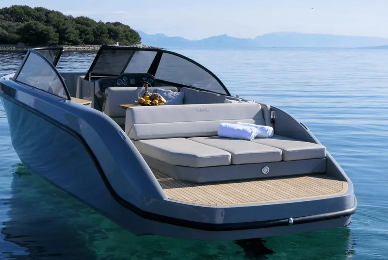 Slide: The Image of Luxurious 2025 Rand Supreme 27 boat on serene water, featuring sleek design and comfortable seating. - 11