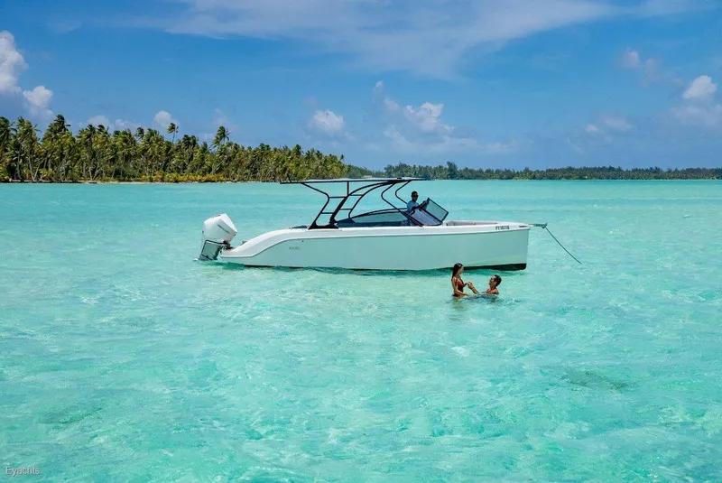 Slide: The Image of Rand Supreme 27 boat in turquoise waters, tropical island background, 2025 model. - 13