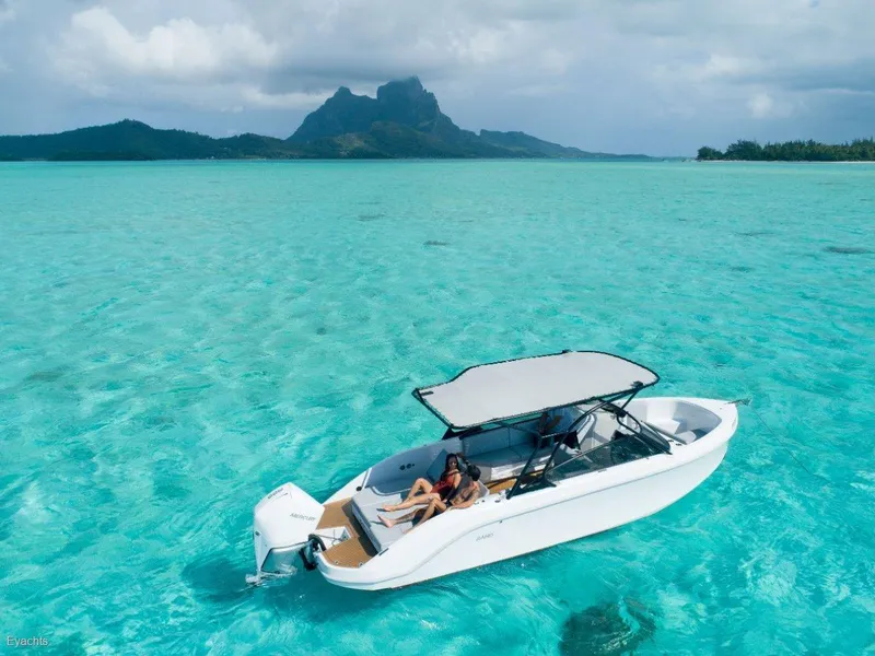 Slide: The Image of 2025 Rand Supreme 27 boat on turquoise water with scenic mountain backdrop. - 14