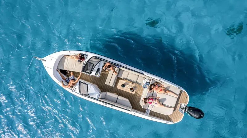 Slide: The Image of Aerial view of Rand Supreme 27 boat, 2025 model, cruising on clear blue water. - 17
