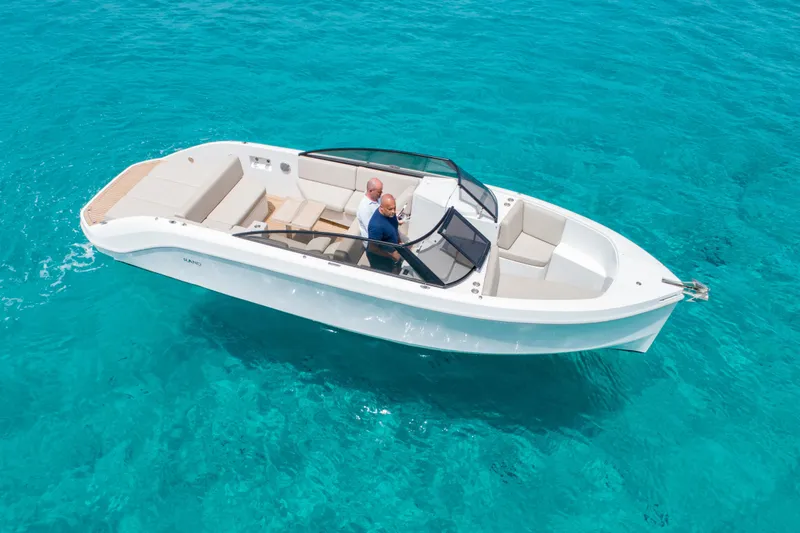 Slide: The Image of 2025 Rand Supreme 27 boat cruising on clear turquoise water. - 18