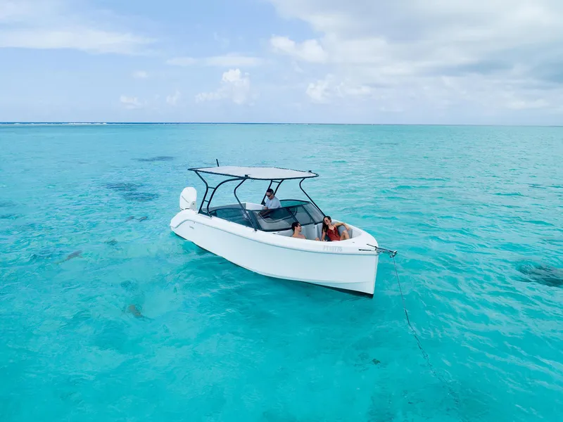 Slide: The Image of A 2025 Rand Supreme 27 boat on clear turquoise water under a partly cloudy sky. - 25