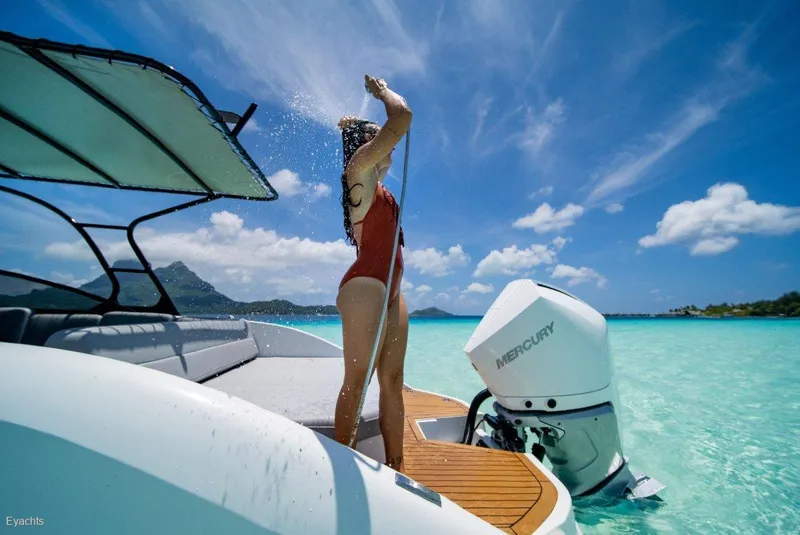 Slide: The Image of Woman showering on Rand Supreme 27 boat, 2025 model, in tropical waters. - 3