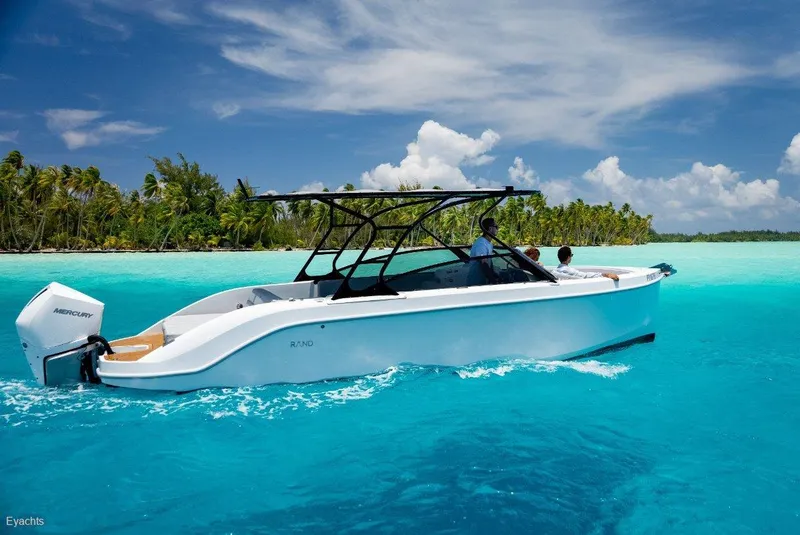Slide: The Image of A Rand Supreme 27 boat cruising in clear turquoise waters, 2025 model. - 4