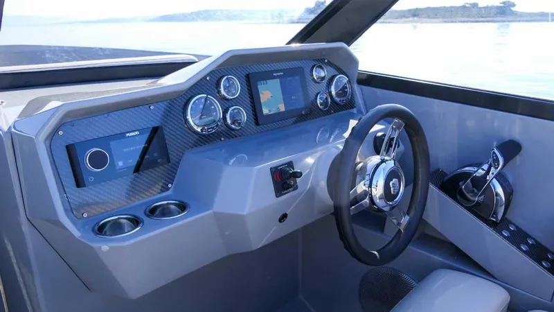 Slide: The Image of Cockpit of 2025 Rand Supreme 27 boat with modern dashboard and steering wheel. - 9