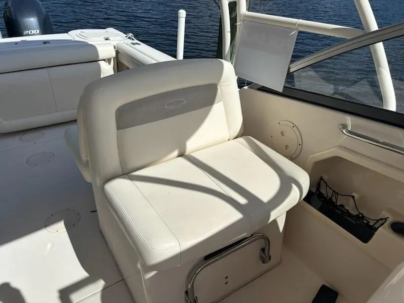 Slide: The Image of 2016 Grady-White Freedom 275 boat interior with white seating and water view. - 20