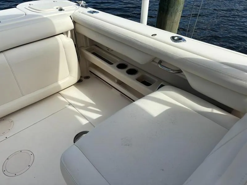Slide: The Image of 2016 Grady-White Freedom 275 boat interior with white seating and cup holders. - 9