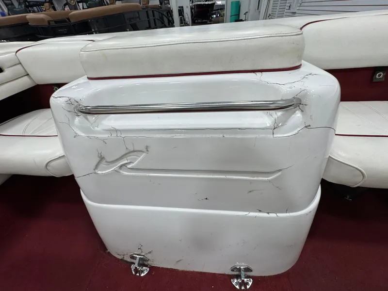 Slide: The Image of 1997 Sea Ray 185 BR boat interior with cracked white seating and red accents. - 11