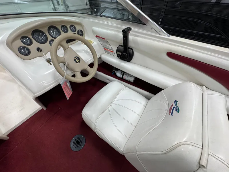 Slide: The Image of 1997 Sea Ray 185 BR boat interior with steering wheel and dashboard controls. - 14