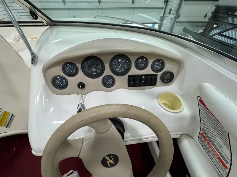Slide: The Image of 1997 Sea Ray 185 BR dashboard with gauges and steering wheel in a boat interior. - 15