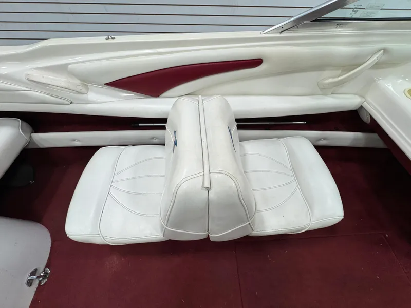 Slide: The Image of 1997 Sea Ray 185 BR boat interior with white seats and red accents. - 16
