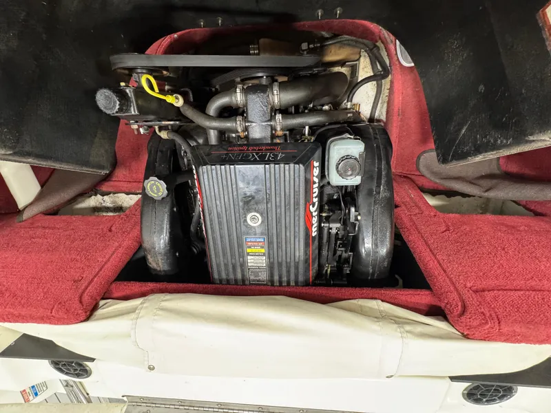 Slide: The Image of Engine of a 1997 Sea Ray 185 BR boat with red interior detailing. - 20
