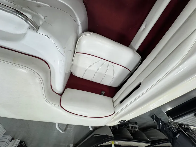 Slide: The Image of 1997 Sea Ray 185 BR boat interior with white and red seating. - 9