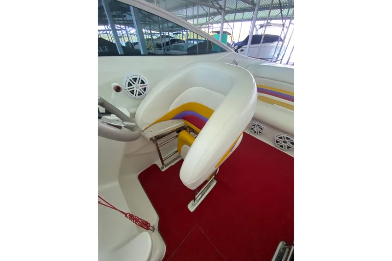 Slide: The Image of 1997 Baja 302 Boss boat interior with white, yellow, and purple seating on red carpet. - 11