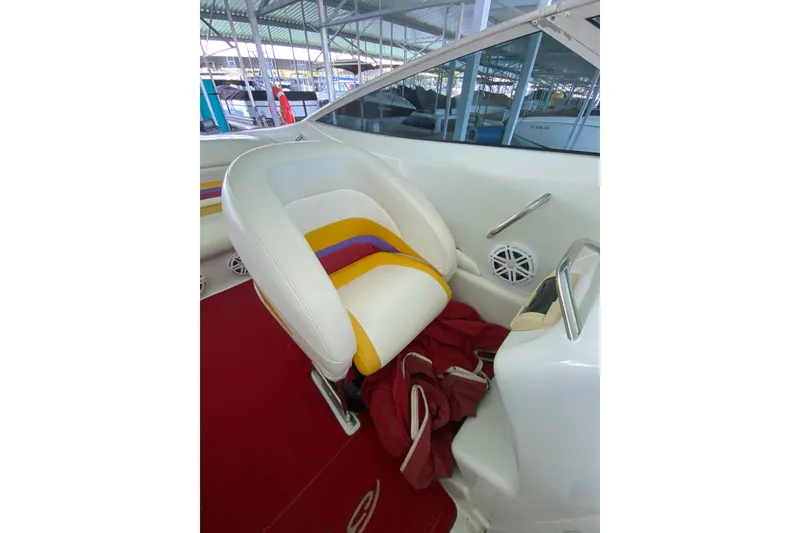 Slide: The Image of Interior of a 1997 Baja 302 Boss boat with colorful seating and red carpet. - 12