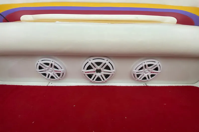 Slide: The Image of Interior of 1997 Baja 302 Boss boat with three white speakers and red carpet. - 15