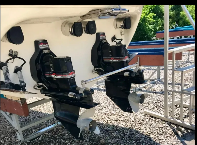 Slide: The Image of 1997 Baja 302 BOSS boat with dual outboard motors on gravel surface. - 7